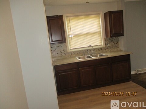 A kitchen with a sink and a window.