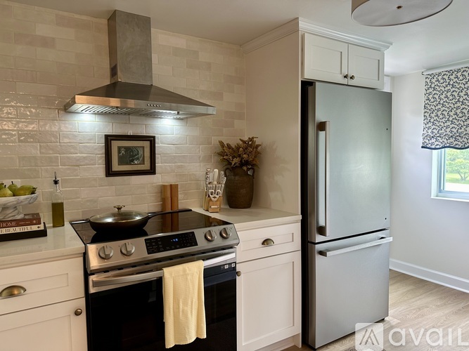 A kitchen with a black stove top oven and a white fridge.