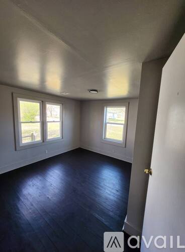A room with wooden floors and white walls.