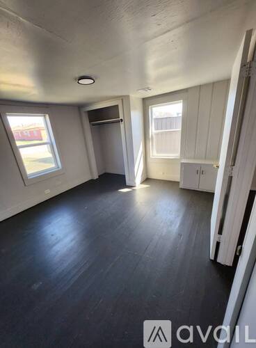A room with wooden floors and white walls.