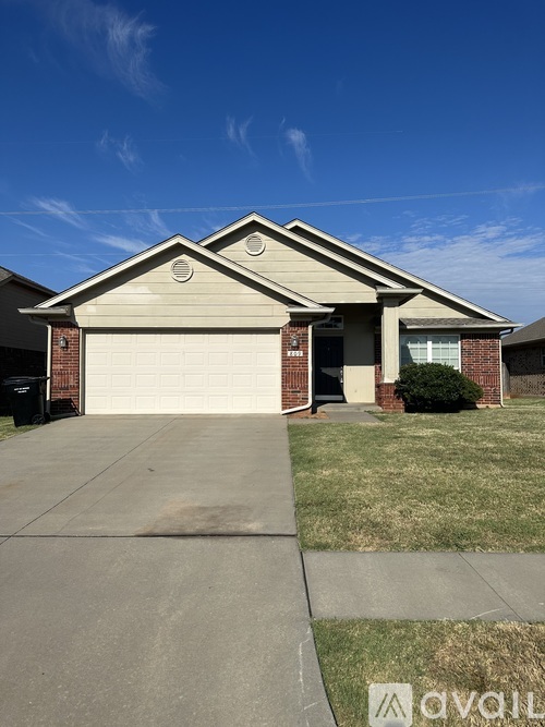 A house with a garage and a driveway in front.