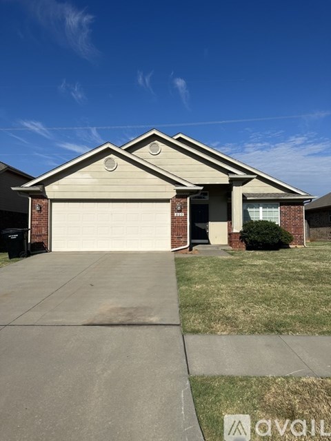 A house with a garage and a driveway in front.