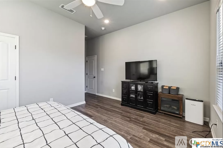 A bedroom with a large bed and a television.