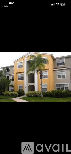 A building with a palm tree in front of it.