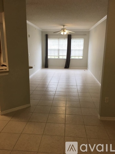 A room with a tiled floor and a ceiling fan.