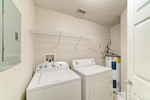 A small laundry room with a washer and dryer.