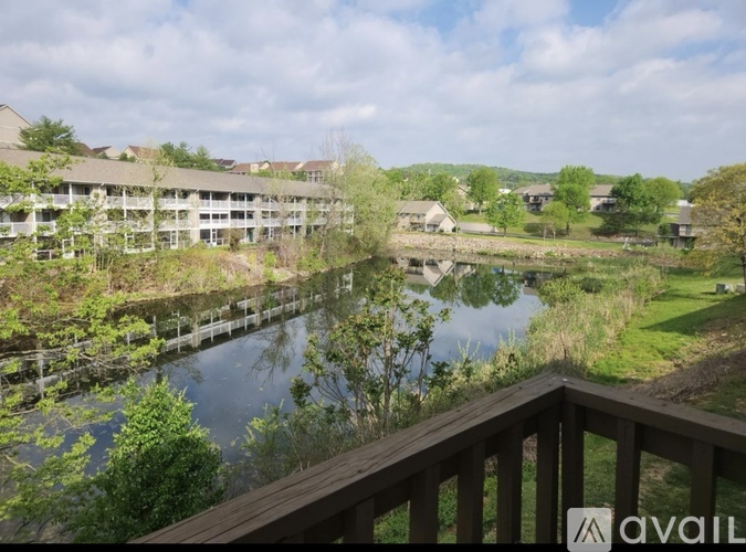 A view from a balcony overlooking a river and a resort.
