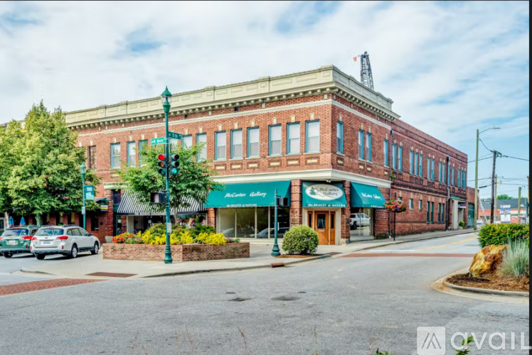 A street view of a building with a green awning and a sign that says "Bakery".
