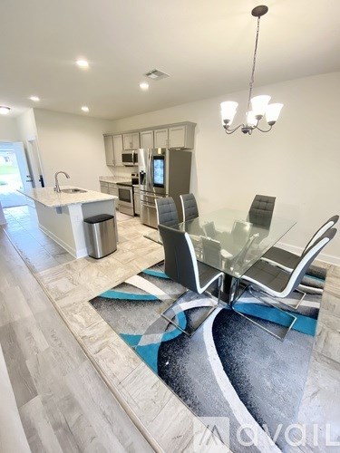 A modern kitchen with a glass table and chairs.