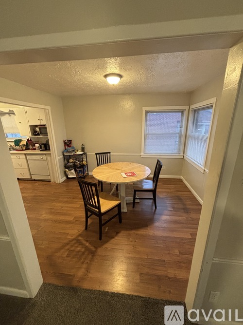 A dining room with a table and chairs.