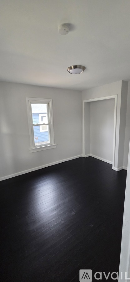 A room with a window and a door.