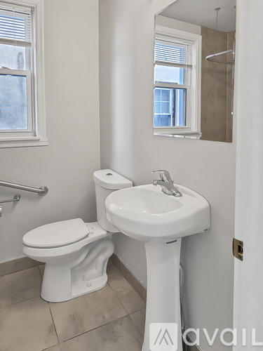 A white toilet and sink in a bathroom.