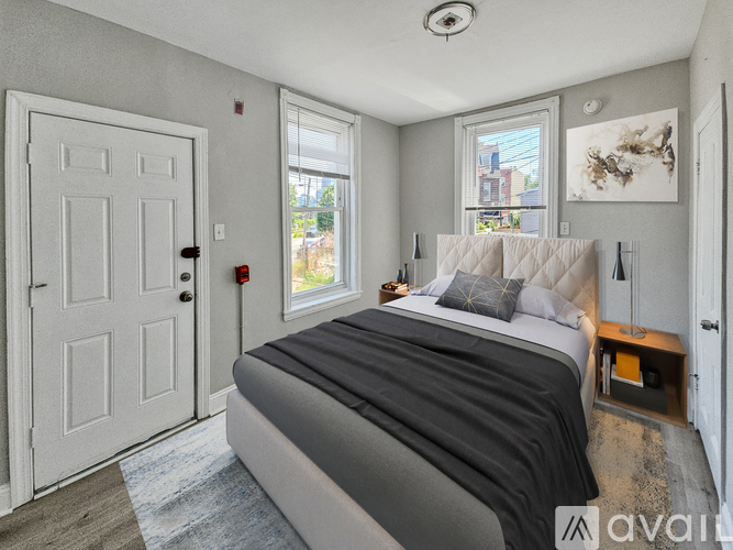 A bedroom with a large bed and a window.
