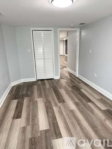 A bedroom with a bed and a dresser.