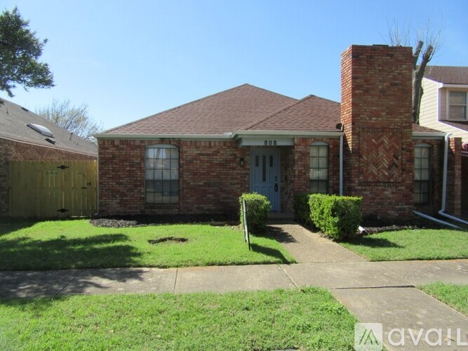 A house with a brick facade and a blue door is for sale.
