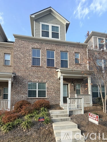 A house with a for sale sign in front of it.