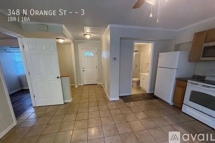 A kitchen with white appliances and a white door.