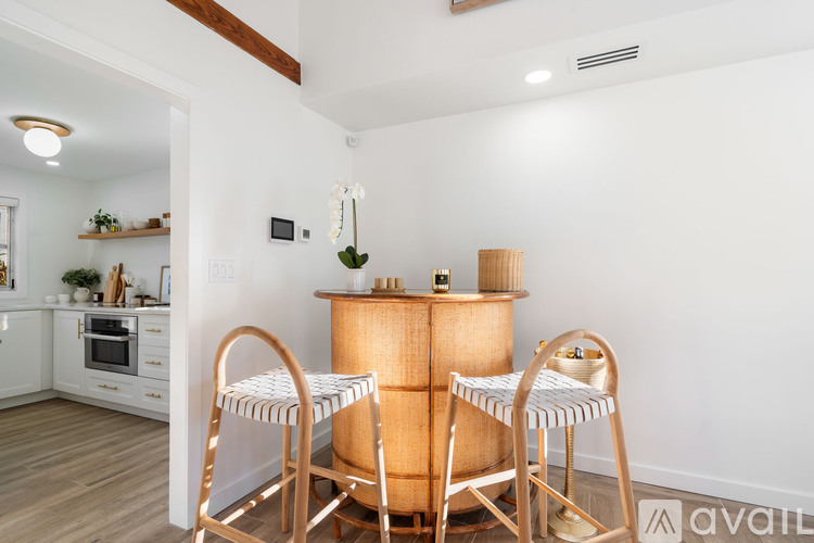 A dining room with a wooden table and chairs.