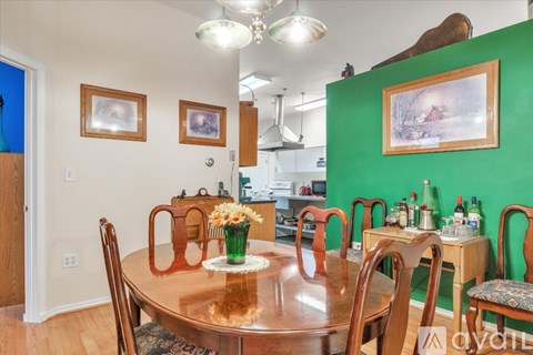 A dining room with a wooden table and chairs.