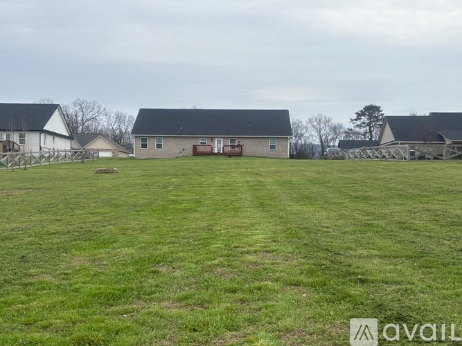 A farm scene with a barn and a house.