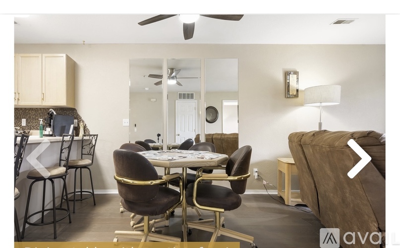 A modern dining room with a round table and chairs.