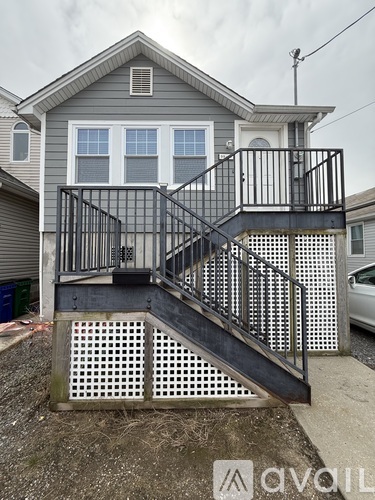 A house with a grey roof and a black metal staircase.