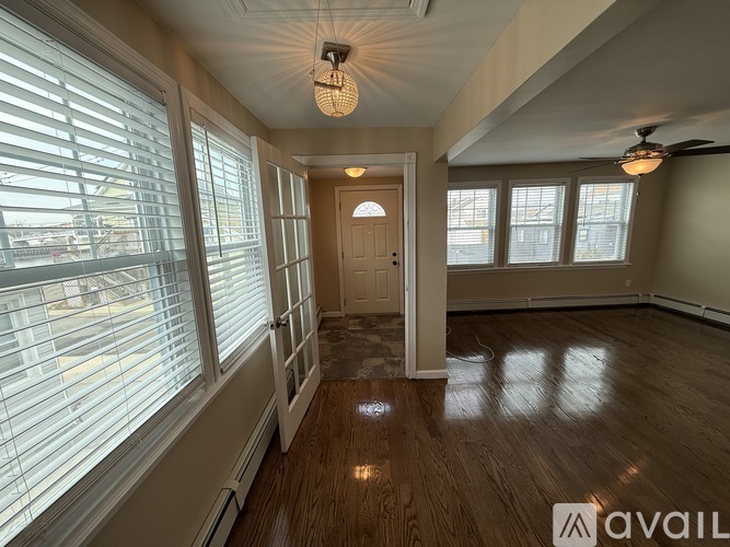 A room with wooden floors and a ceiling fan.