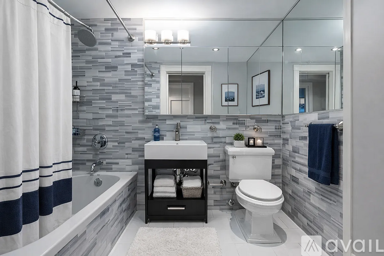 A bathroom with a stone wall and a white toilet.