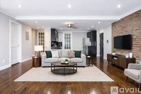 A living room with a white couch and a coffee table in the center.