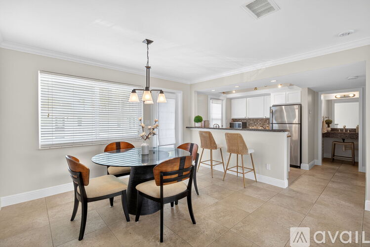 A dining room with a round table and chairs.