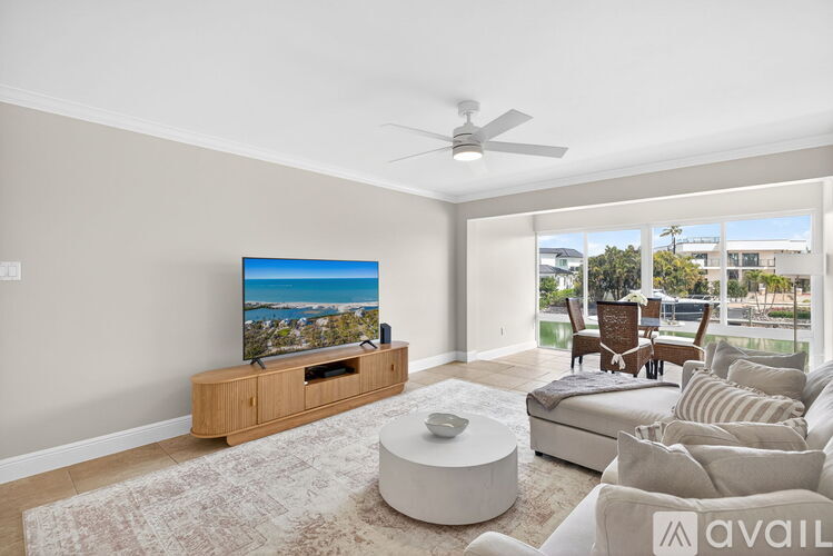 A living room with a television and a couch.