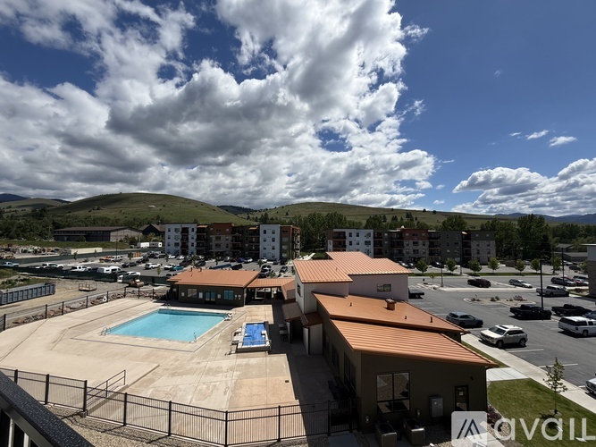 A large building with a pool in the middle of a parking lot.