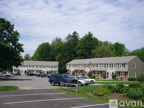 A parking lot with cars and a building in the background.