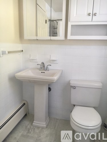 A white sink and toilet in a bathroom.