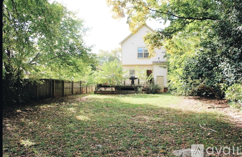 A house is surrounded by trees and bushes.