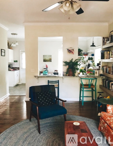 A living room with a blue chair and a coffee table.