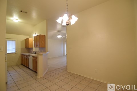 A kitchen with white cabinets and a countertop is shown.