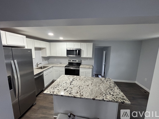 A kitchen with granite countertops and stainless steel appliances.