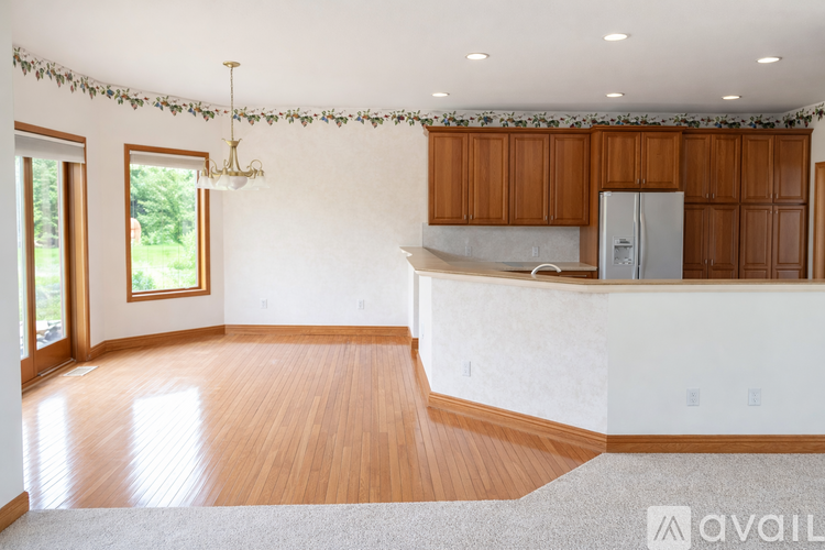 A kitchen with wooden cabinets and a white fridge.