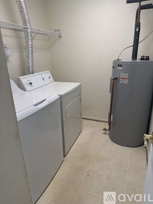 A small laundry room with a washer and dryer.