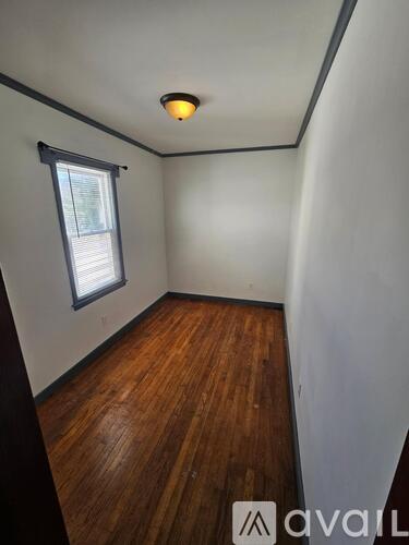 A room with wooden floors and a window.