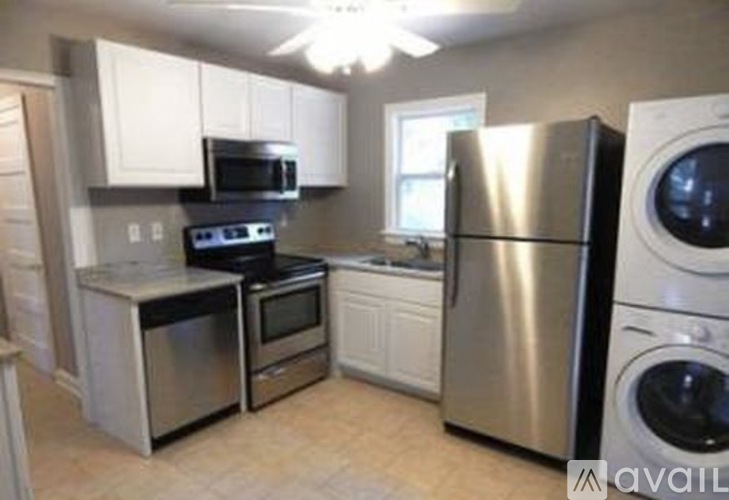 A kitchen with a stainless steel refrigerator and oven.