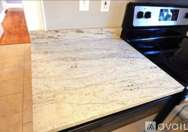 A kitchen countertop with a black oven behind it.
