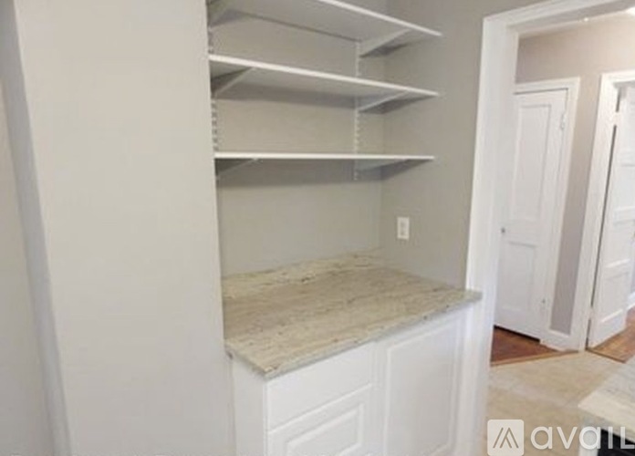 A kitchen pantry with a countertop and shelves.