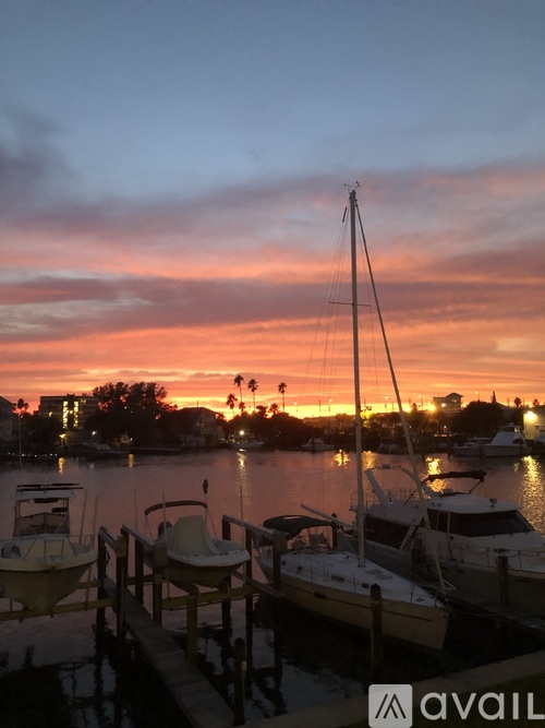 A beautiful sunset over a marina with boats docked.
