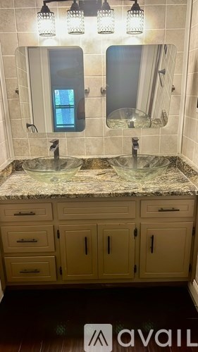 A kitchen with granite countertops and a fridge with a picture of a beach on the wall.