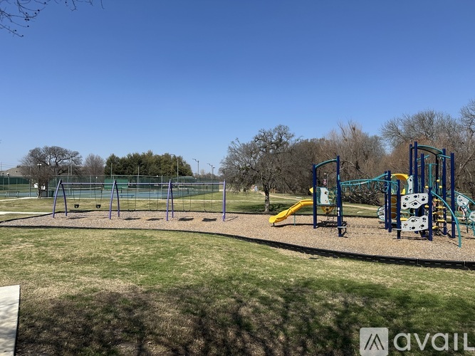 A playground with a slide, swings, and monkey bars.