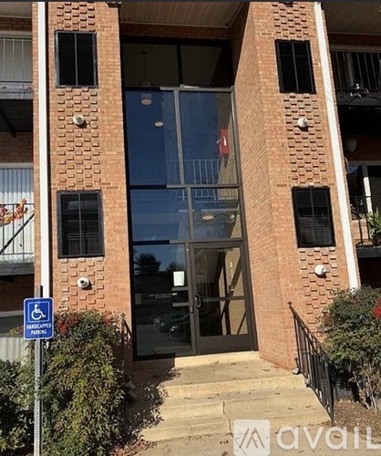 A building with a blue and white handicap sign in front of it.