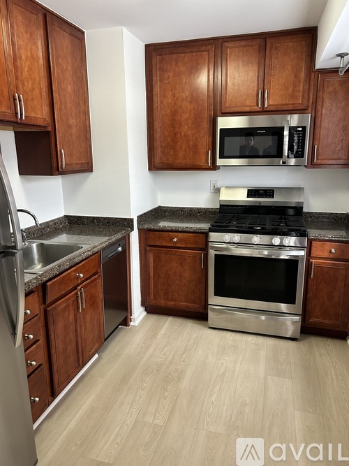 A kitchen with wooden cabinets and stainless steel appliances.