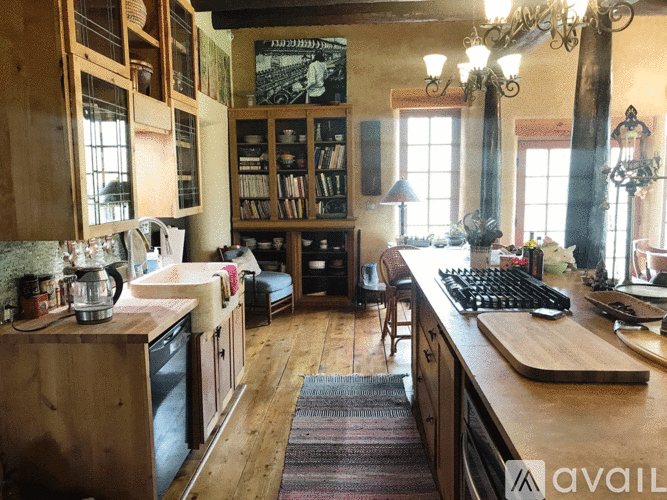 A kitchen with wooden cabinets and a large island.